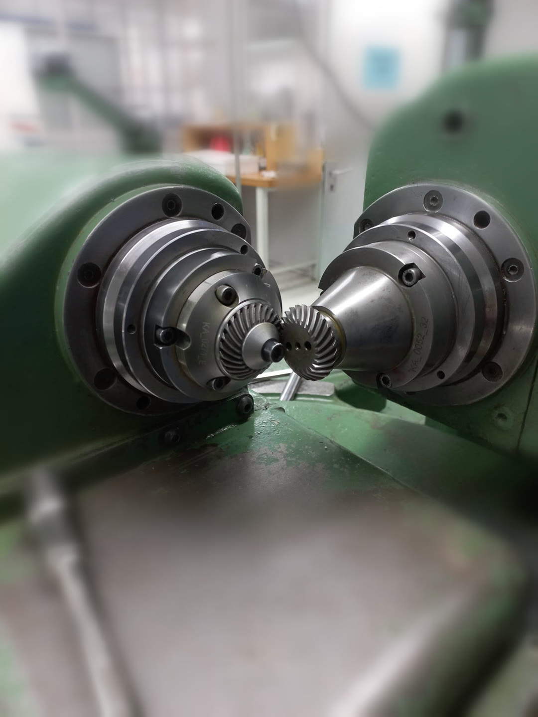 Spiral bevel gear pair mounted on the two spindles of a test-rolling machine